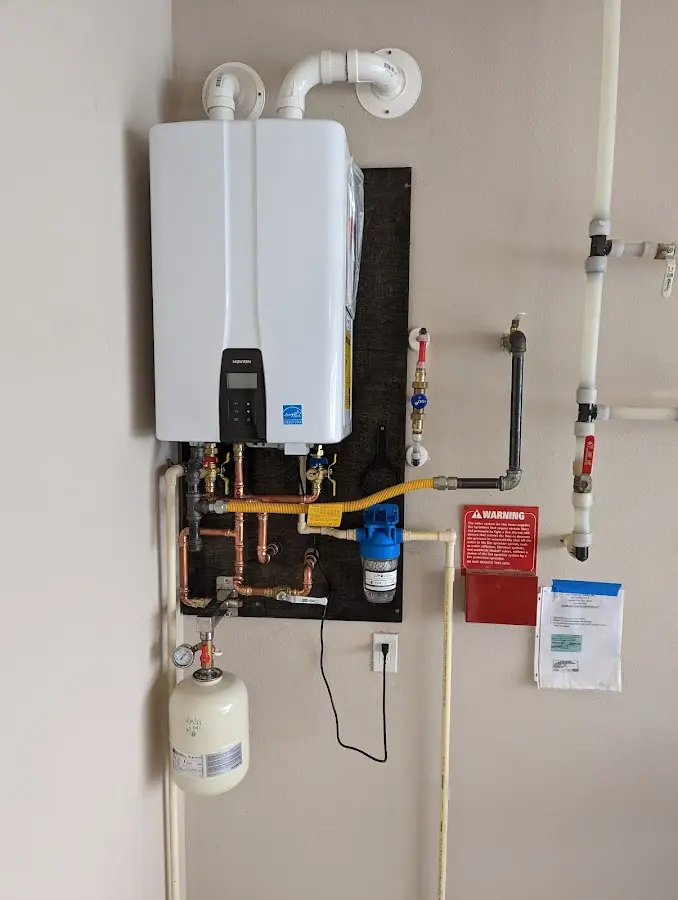 Professional plumber installing copper piping in a Williston home